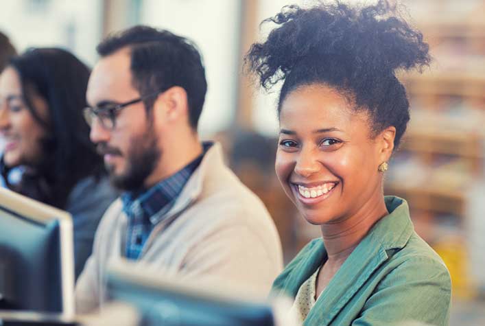 A professional smiling while continuing education